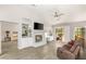 Inviting living room with a fireplace, built-in shelving, and sliding glass doors to the outside at 9445 January Dr, Las Vegas, NV 89134