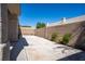 Backyard features a concrete patio bordered by block wall, with space for outdoor activities at 9710 Geiger Peak Ct, Las Vegas, NV 89148
