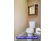 Bathroom with white toilet and vintage style wood cabinet at 9710 Geiger Peak Ct, Las Vegas, NV 89148