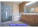 Bathroom featuring double vanity, large mirror, standalone shower, and soaking tub at 9710 Geiger Peak Ct, Las Vegas, NV 89148