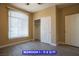 Bedroom featuring wood-look floors, neutral paint, closet, and natural light from a window at 9710 Geiger Peak Ct, Las Vegas, NV 89148