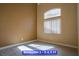 Bedroom with high ceilings, wood-look floors, neutral paint, and natural lighting from a large window at 9710 Geiger Peak Ct, Las Vegas, NV 89148