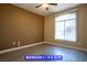 Bedroom featuring wood-look floors, neutral paint, ceiling fan, and natural lighting from a large window at 9710 Geiger Peak Ct, Las Vegas, NV 89148
