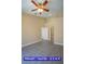 Large primary bedroom with neutral paint, ceiling fan, and dual closets for ample storage at 9710 Geiger Peak Ct, Las Vegas, NV 89148