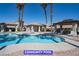 Community pool area with lounge chairs and covered seating at 9710 Geiger Peak Ct, Las Vegas, NV 89148