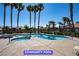 Large community pool with jacuzzi and palm trees at 9710 Geiger Peak Ct, Las Vegas, NV 89148