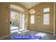 Light-filled dining room with sliding glass doors and modern lighting at 9710 Geiger Peak Ct, Las Vegas, NV 89148