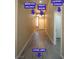 Bright hallway featuring modern flooring leading to the living area, front door, and garage at 9710 Geiger Peak Ct, Las Vegas, NV 89148