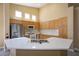 Modern kitchen featuring stainless steel appliances, a large island, bright countertops, and custom cabinets at 9710 Geiger Peak Ct, Las Vegas, NV 89148