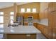 Bright kitchen with stainless steel appliances, a large island, bright countertops, and custom cabinetry at 9710 Geiger Peak Ct, Las Vegas, NV 89148