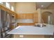 Modern kitchen with stainless appliances, custom cabinets, bright countertops and a view into the dining area at 9710 Geiger Peak Ct, Las Vegas, NV 89148