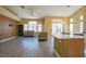 Open floor plan featuring wood-look floors, living room seating and island in the kitchen at 9710 Geiger Peak Ct, Las Vegas, NV 89148