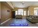 Inviting living room featuring lots of natural light, ceiling fan and modern flooring at 9710 Geiger Peak Ct, Las Vegas, NV 89148