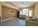 Comfortable living room with ceiling fan, large arched window, and neutral paint at 9710 Geiger Peak Ct, Las Vegas, NV 89148