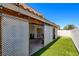 Backyard featuring a covered patio area with turf and a white block wall at 982 Flapjack Dr, Henderson, NV 89014
