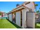 View of the patio area from the backyard, complete with turf, fence and pool at 982 Flapjack Dr, Henderson, NV 89014