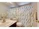 The well-maintained bathroom features a shower-tub combo and a decorative shower curtain at 982 Flapjack Dr, Henderson, NV 89014