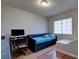Well-lit bedroom featuring a daybed, desk area and wood-look floors at 982 Flapjack Dr, Henderson, NV 89014