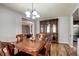 Cozy dining room featuring hardwood floors, chandelier, and a beautiful china cabinet at 982 Flapjack Dr, Henderson, NV 89014