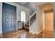 Welcoming entryway featuring hardwood floors, a staircase, and a stylish front door at 982 Flapjack Dr, Henderson, NV 89014