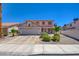 Charming two-story home featuring a tile roof, a two-car garage, and well-maintained landscaping at 982 Flapjack Dr, Henderson, NV 89014