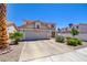 Charming two-story home featuring a tile roof, a two-car garage, and well-maintained landscaping at 982 Flapjack Dr, Henderson, NV 89014