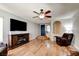 Inviting living room featuring hardwood floors, a fireplace, and a modern ceiling fan at 982 Flapjack Dr, Henderson, NV 89014