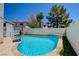 Backyard swimming pool and patio area enclosed with a white fence at 982 Flapjack Dr, Henderson, NV 89014