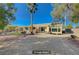 Desert landscaped backyard with seating area and mature palm tree at 10201 Premia Pl, Las Vegas, NV 89135