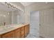 Bright bathroom featuring double sinks with a shower and separate walk-in closet at 10201 Premia Pl, Las Vegas, NV 89135