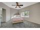 Bedroom featuring a modern ceiling fan, carpet floors, lots of natural light, and a neutral color palette at 10201 Premia Pl, Las Vegas, NV 89135