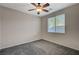 Bedroom featuring a ceiling fan, window with view, and soft carpet at 10201 Premia Pl, Las Vegas, NV 89135