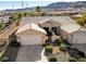 Inviting single-Gathering home featuring a two-car garage, complemented by well-manicured landscaping and tasteful exterior details at 10201 Premia Pl, Las Vegas, NV 89135