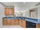 Kitchen has stainless steel appliances, wood cabinets, and a breakfast bar that opens to the living space at 10201 Premia Pl, Las Vegas, NV 89135