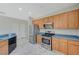 The kitchen has stainless steel appliances, wood cabinets, and a modern design at 10201 Premia Pl, Las Vegas, NV 89135