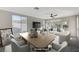 Staged living room featuring lots of natural light, stylish furnishings, modern ceiling fan, and a neutral color palette at 10201 Premia Pl, Las Vegas, NV 89135