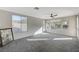 Living room featuring lots of natural light, carpet floors, neutral color palette, and a modern ceiling fan at 10201 Premia Pl, Las Vegas, NV 89135