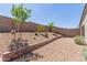 Large backyard featuring desert landscaping and a retaining wall at 10257 Sequoia Falls Pl, Las Vegas, NV 89149