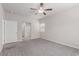 Large bedroom boasts neutral walls, plush carpet, a ceiling fan, and a doorway leading to the bathroom at 10257 Sequoia Falls Pl, Las Vegas, NV 89149