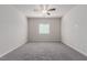 Spacious bedroom features a ceiling fan, neutral walls, carpeted floors, and a window with blinds at 10257 Sequoia Falls Pl, Las Vegas, NV 89149
