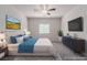 Inviting bedroom with a tufted headboard, soft blue accents, and a mounted television at 10257 Sequoia Falls Pl, Las Vegas, NV 89149