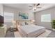 Serene bedroom with plush bedding, elegant lamps, and a calming, neutral color palette at 10257 Sequoia Falls Pl, Las Vegas, NV 89149