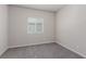 Neutral-toned bedroom featuring plush carpeting, a window with blinds, and ample natural light at 10257 Sequoia Falls Pl, Las Vegas, NV 89149