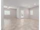 Large empty room featuring tile floors, a ceiling fan, and a glass door leading to the outdoors at 10257 Sequoia Falls Pl, Las Vegas, NV 89149