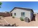Rear exterior of home with rock landscaping, and an efficient AC unit at 10257 Sequoia Falls Pl, Las Vegas, NV 89149