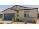 Single-story home featuring desert landscaping, gray accents, and a two-car garage at 10257 Sequoia Falls Pl, Las Vegas, NV 89149