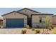Charming single-story home featuring desert landscaping and a gray two-car garage at 10257 Sequoia Falls Pl, Las Vegas, NV 89149