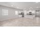 Open-concept kitchen and living area with sleek white cabinets and stainless steel appliances at 10257 Sequoia Falls Pl, Las Vegas, NV 89149