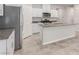 Modern kitchen boasts white cabinets, stainless steel appliances, and a granite countertop island at 10257 Sequoia Falls Pl, Las Vegas, NV 89149