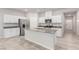 Modern kitchen boasts white cabinets, stainless steel appliances, and a granite countertop island at 10257 Sequoia Falls Pl, Las Vegas, NV 89149